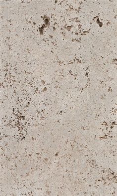 a white and brown speckled concrete surface with small holes in the middle, on top of it