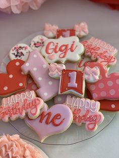 some decorated cookies are on a glass plate