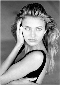 a black and white photo of a woman with her hair in a high pony tail