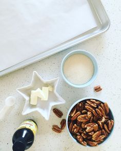 pecans, cheese, and other ingredients are sitting on a counter top next to a baking pan