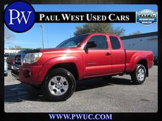 a red pick up truck parked in a parking lot