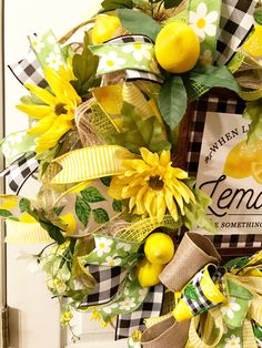 a yellow and green wreath with sunflowers, lemons and gingham