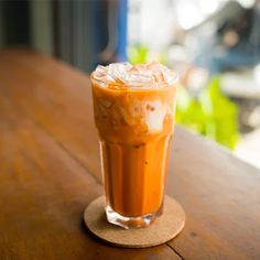 an iced drink sitting on top of a wooden table