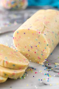 a loaf of cake batter with sprinkles next to it on a counter