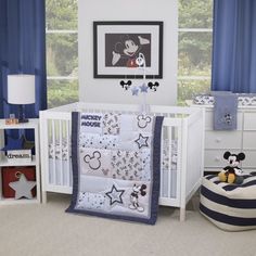 a mickey mouse crib bedding set in a child's room