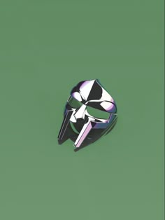 a black and white mask ring on a green background