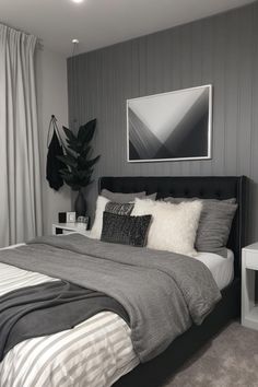 a bedroom with grey walls and white bedding, black headboard, gray rugs