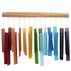 a wind chime hanging from a wooden beam with several different colored bars attached to it