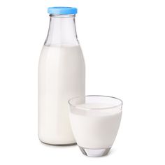 a glass and bottle of milk sitting next to each other