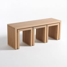 two wooden benches sitting next to each other on a white surface in front of a wall