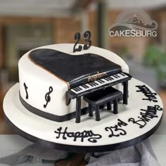 a cake that has a piano on top of it with music notes and musical symbols