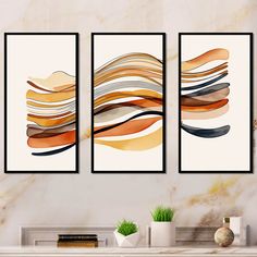 three abstract paintings hanging on a wall above a fireplace