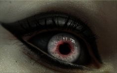 an evil looking woman's eye with blood on the inside of her irise