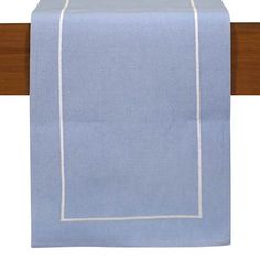 a light blue table runner with white stitching on the border and wood frame around it