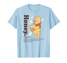 a blue t - shirt with an image of a winnie the pooh holding a book