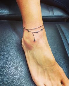 a woman's foot with a tattoo on it