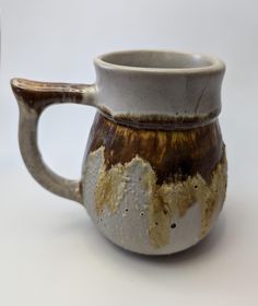 a brown and white coffee mug sitting on top of a table