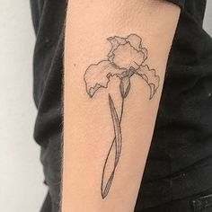 a black and white photo of a flower on the arm