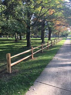 a wooden fence in the middle of a park