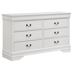 a white dresser with four drawers and two pulls on the bottom drawer, in front of a