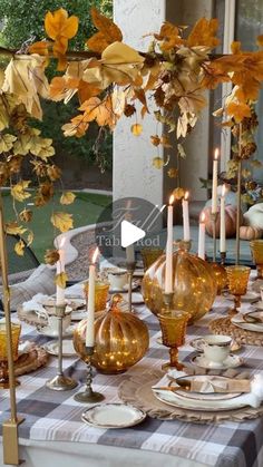 the table is set with candles and dishes