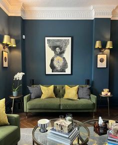 a living room with blue walls and green couches