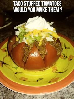 a yellow plate topped with a tomato covered in toppings