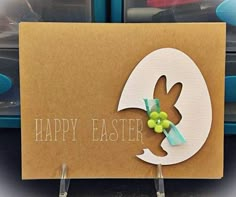 an easter card with the word happy easter written on it and a paper bunny sticking out of its hole