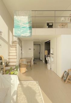 a living room filled with furniture next to a staircase