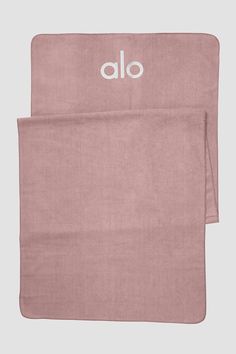 two towels with the word alo printed on them, one in pink and one in white