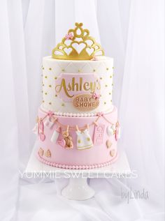 a pink and gold baby shower cake with teddy bears