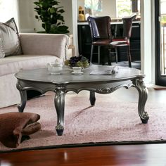 a living room with a couch, chair and coffee table in the middle of it