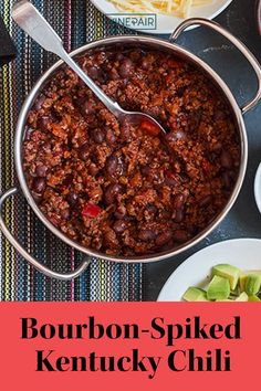 bourbon - spiced kentucky chili in a large pot on a table with other dishes