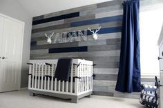 a baby crib in front of a wooden wall with the name mary nursery inspiration on it