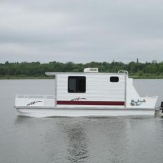 a white boat floating on top of a lake