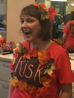 a woman wearing a shirt that says ask with leaves around her neck and the word ask on it