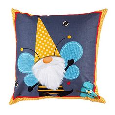 a blue pillow with a gnome face and yellow polka dot dots on it's side