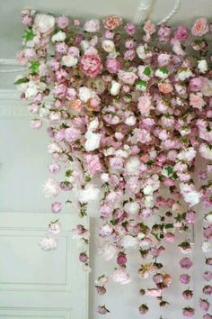 pink and white flowers hanging from the ceiling