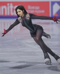 a female figure skating on an ice rink