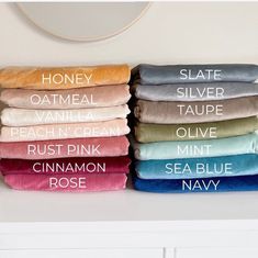 towels stacked on top of each other with the names of different colors and sizes in them