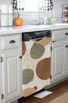 a dishwasher sitting in the middle of a kitchen next to a counter top