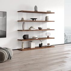 a living room filled with furniture and a large window overlooking the cityscape in black and white