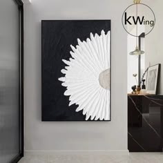 a black and white painting hanging on the wall next to a mirror in a bathroom