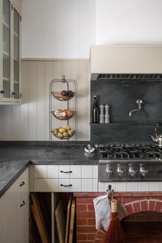 a stove top oven sitting inside of a kitchen next to a brick oven and counter