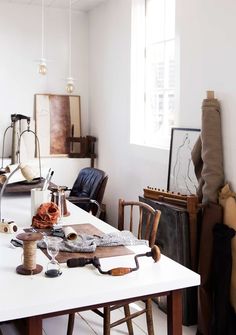 a white table topped with lots of crafting supplies