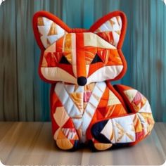 a stuffed fox sitting on top of a wooden floor