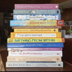 a stack of children's books sitting on top of a table in a living room