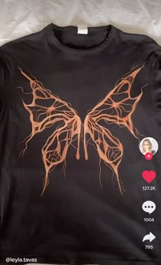 a t - shirt with an image of a butterfly on it's chest and two hearts