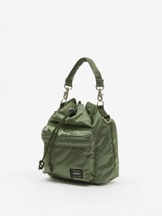 This Porter-Yoshida & Co shoulder bag has a detachable strap and a duffel-style drawstring closure. It’s crafted from the brand’s tough, military-inspired sage green nylon twill. 100% Nylon Detachable Strap Drawstring Closure Zip Pocket Woven Brand Patch Porter Bag, Canvas Duffel Bag, Porter Yoshida, Military Inspired, Nylon Bag, Diy Bag, Green Bag, Duffel Bag