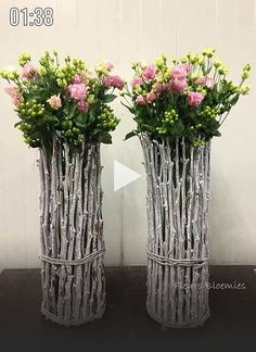 two vases that have flowers in them